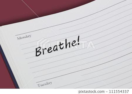 Breathe reminder message in an open diary 111554337