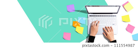 Laptop computer with many sticky notes 111554987