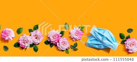 Face masks with pink roses overhead view Face masks with pink roses overhead view 111555048