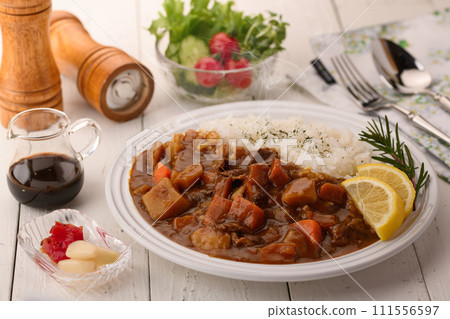 Curry with plenty of vegetables served with salad Curry with plenty of vegetables served with salad 111556597