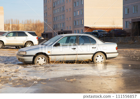 old Nissan Primera car in frozen water. winter accident. Pavlodar, Kazakhstan - 12.28.2022. 111556857