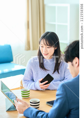 Young woman listening to a man in a suit Young woman listening to a man in a suit 111558308
