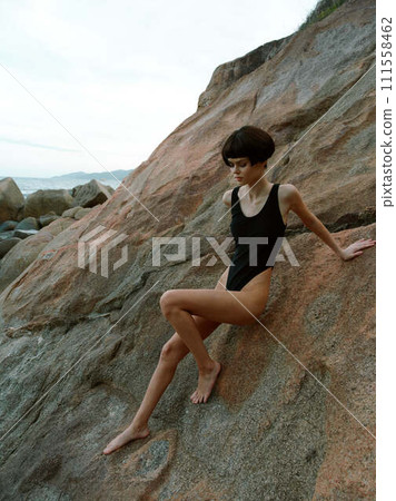 Summertime Sensuality: A Beautiful Woman in Bikini Posing on the Beach, Capturing the Essence of Relaxation and Beauty. Summertime Sensuality: A Beautiful Woman in Bikini Posing on the Beach, Capturing the Essence of Relaxation and Beauty. 111558462