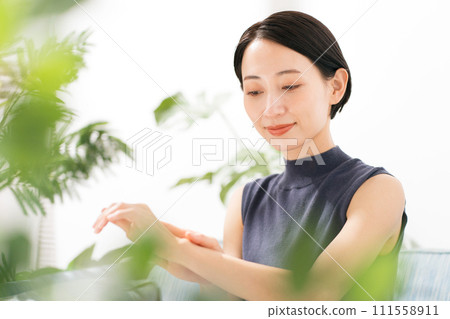 A woman moisturizing her arms A woman moisturizing her arms 111558911