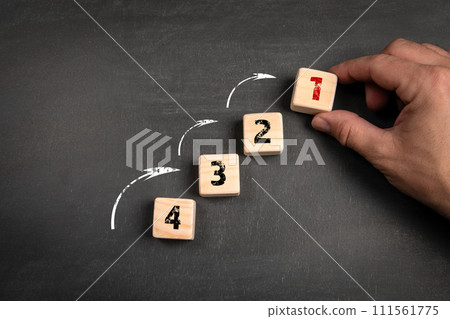 Competition and development concept. Wooden blocks on a dark chalkboard background Competition and development concept. Wooden blocks on a dark chalkboard background 111561775