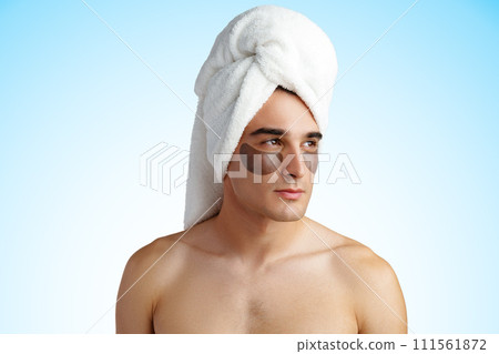 Portrait of attractive young male model with eye patches on white background 111561872