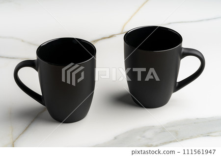 Ceramic cups on marble table against gray background Ceramic cups on marble table against gray background 111561947