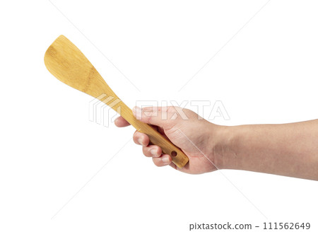 man's hand holding a wooden spoon man's hand holding a wooden spoon 111562649