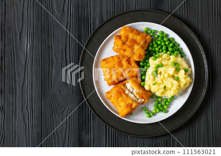 fried fish with mashed potatoes and green peas 111563021