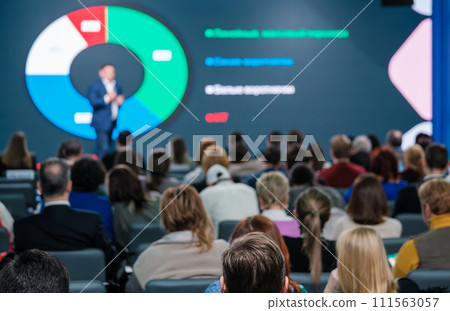 Professional speaker presenting to attentive audience at business conference 111563057