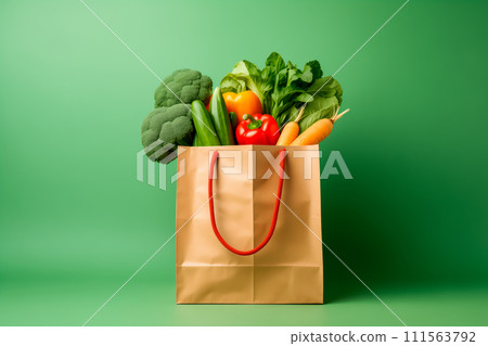 Craft brown shopping paper bag and grocery on blue background. Delivery concept Craft brown shopping paper bag and grocery on blue background. Delivery concept 111563792