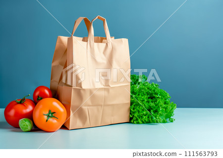 Craft brown shopping paper bag and grocery on blue background. Delivery concept Craft brown shopping paper bag and grocery on blue background. Delivery concept 111563793