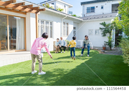 Three generation family playing in the garden Three generation family playing in the garden 111564458
