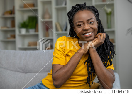 Cute african american woman in yellow tshirt smiling nicely 111564546