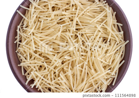 Small egg noodles in brown clay bowl isolated on white background Small egg noodles in brown clay bowl isolated on white background 111564898