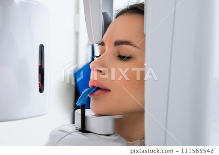 Young Woman Receiving Panoramic X ray for Teeth Examination.  111565542