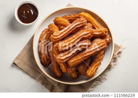 Top view of heap of traditional Spanish dessert churros on the plate with chocolate sauce 111566229