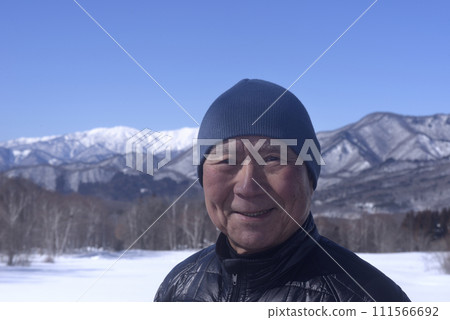 Senior smiling with snowy mountains in the background Senior smiling with snowy mountains in the background 111566692