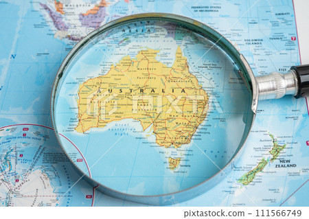 Bangkok, Thailand  January 20, 2022 Australia, Magnifying glass close up with colorful world map, travel, geography, tourism and exploration. 111566749