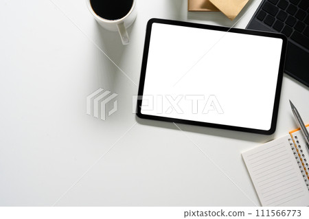Top view office desk with digital tablet, laptop, coffee cup and notepad. Blank display for advertising Top view office desk with digital tablet, laptop, coffee cup and notepad. Blank display for advertising 111566773