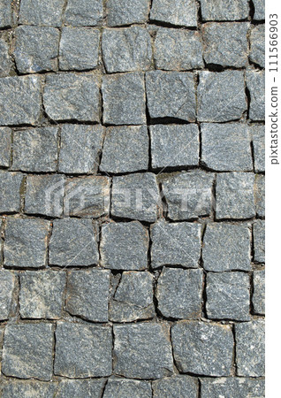 An old stone pavement. The old road. Stone masonry. Gray granite. Roads of the old city. 111566903