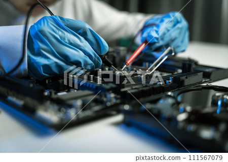 Hands repairing electronic devices. Electronic technician. Hands repairing electronic devices. Electronic technician. 111567079