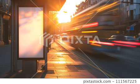 Bus stop near the road with empty banner mockup and cars passing by in blur with sunset cityscape at the background 111567225