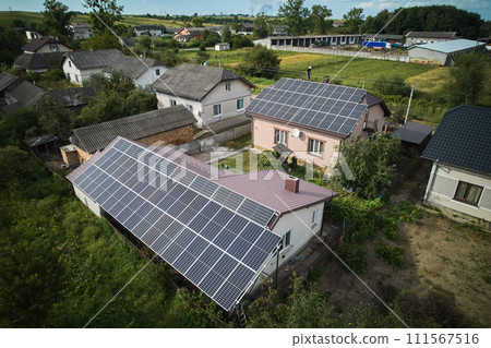 Aerial top view of new modern house cottage with solar photovoltaic panel system on house roof 111567516