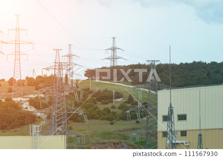 High voltage towers with sky background. Power line support with wires for electricity transmission. High voltage grid tower with wire cable at distribution station. Energy industry, energy saving 111567930
