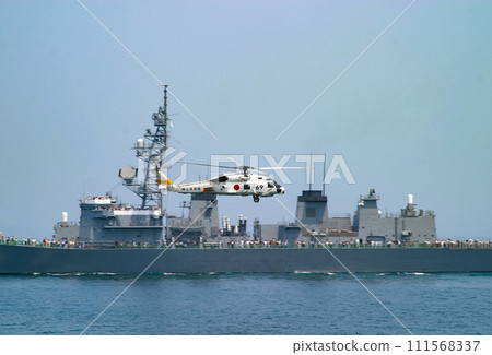 Maritime Self-Defense Force helicopter SH-60J passing by a destroyer 111568337