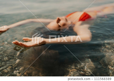 Happy woman sea relaxing floating in transparent sea water on summer holiday. Travel leisure recreation lifestyle, female in nature. 111568389