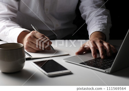 Hands of men using a personal computer 111569564