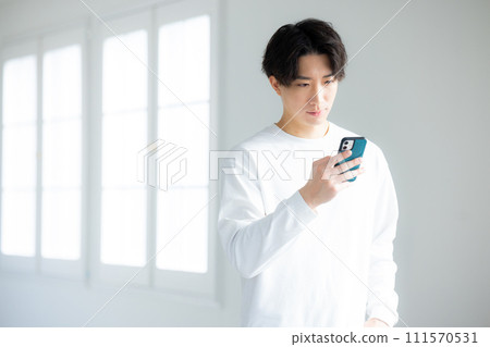 A man using a smartphone A man using a smartphone 111570531