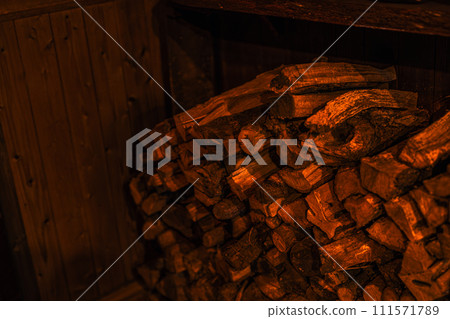 A photo of firewood piled up in a corner of an old folk house 111571789