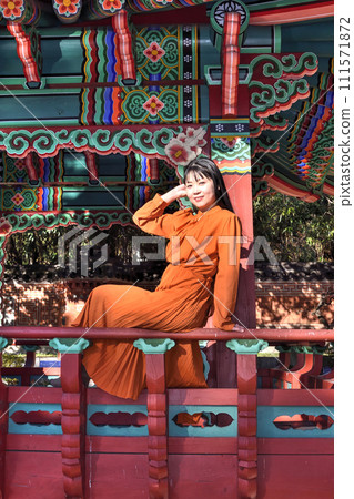 A woman sitting on the railing of a Korean restaurant A woman sitting on the railing of a Korean restaurant 111571872