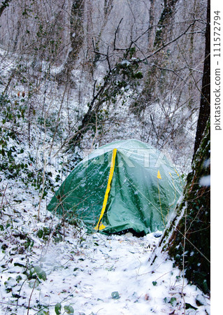 Tent is covered with snow, overnight hikers in forest Tent is covered with snow, overnight hikers in forest 111572794