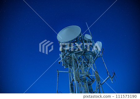 Radio tower shining in the night sky 111573190