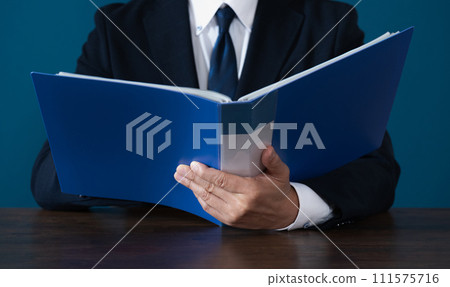 Hand of a businessman checking a file 111575716