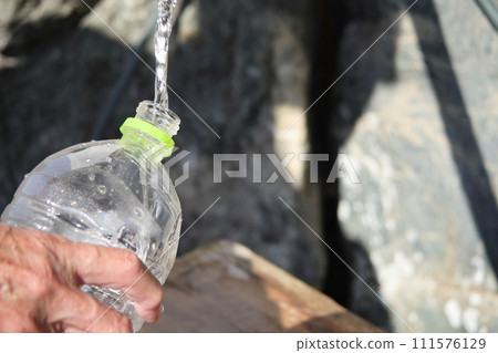 Put water in a plastic bottle Put water in a plastic bottle 111576129