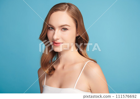 Beautiful young woman with clean fresh skin on blue background, Face care, Facial treatment, Cosmetology, beauty and spa, women portrait. 111576692