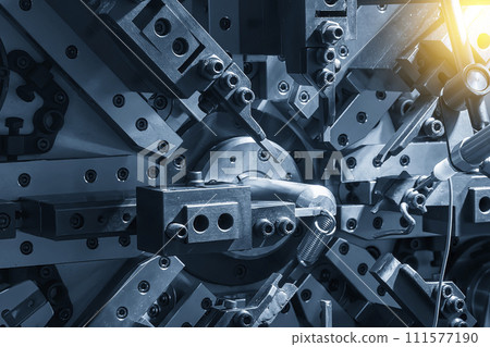 Close up the coil spring forming machine in light blue scene. 111577190