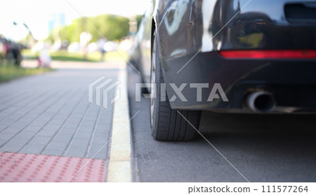 Car is parked near yellow median strip closeup 111577264