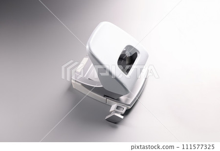 Closeup of white hole punch on gray background 111577325