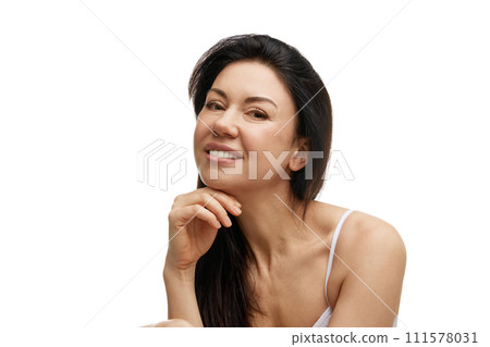 Portrait of brunette middle-aged woman, cheerfully smiling against white studio background. Anti-aging procedures. 111578031