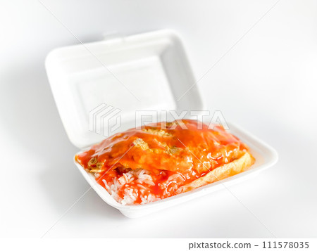 Omelet with pork and chili sauce on rice in the white food tray Omelet with pork and chili sauce on rice in the white food tray 111578035