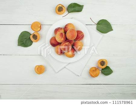 Ripe apricots on the table. apricots and green leaves. Flat lay. Top view. Copyspace. Ripe apricots on the table. apricots and green leaves. Flat lay. Top view. Copyspace. 111578961