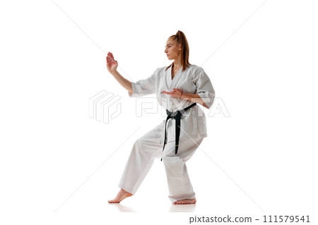 Master black belt Tae Kwon Do teacher in uniform standing in position isolated over white background. Master black belt Tae Kwon Do teacher in uniform standing in position isolated over white background. 111579541