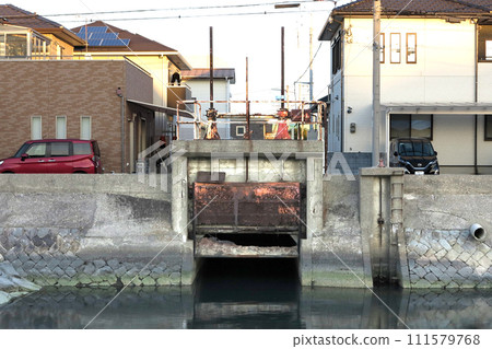 Deteriorated water gate in a residential area Deteriorated water gate in a residential area 111579768