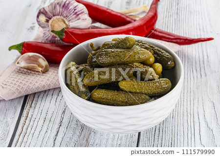 Marinated small cucumbers in the bowl 111579990