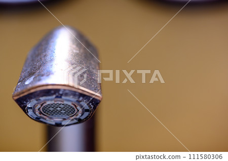 Underside of a bathroom sink aerator on a faucet. 111580306